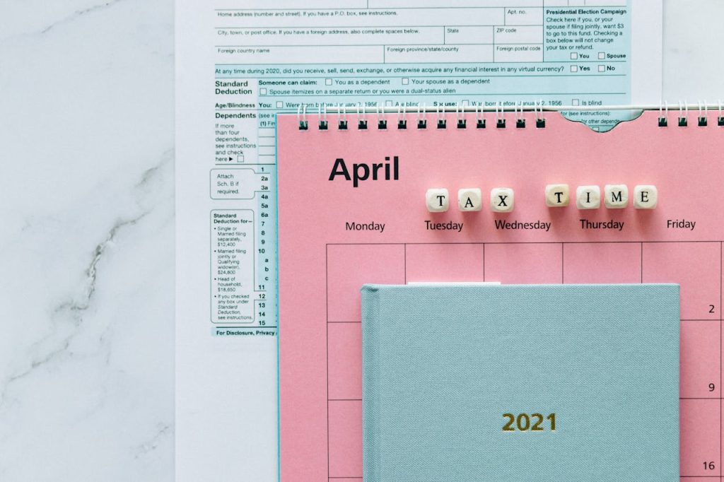 April calendar with tax forms, highlighting tax time reminders for financial tasks.